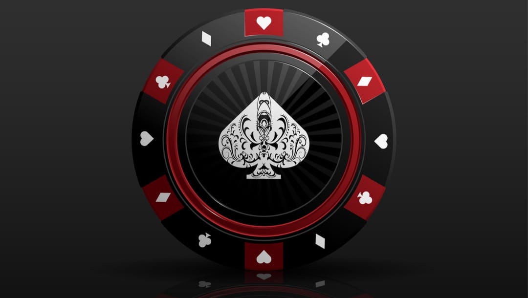 Closeup vector of a black poker chip with red and white playing card details isolated against black background.