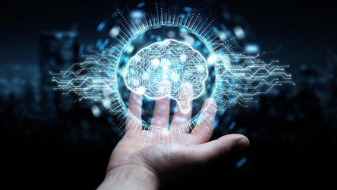 A rendering of a man’s hand with a symbolic AI brain floating above it.