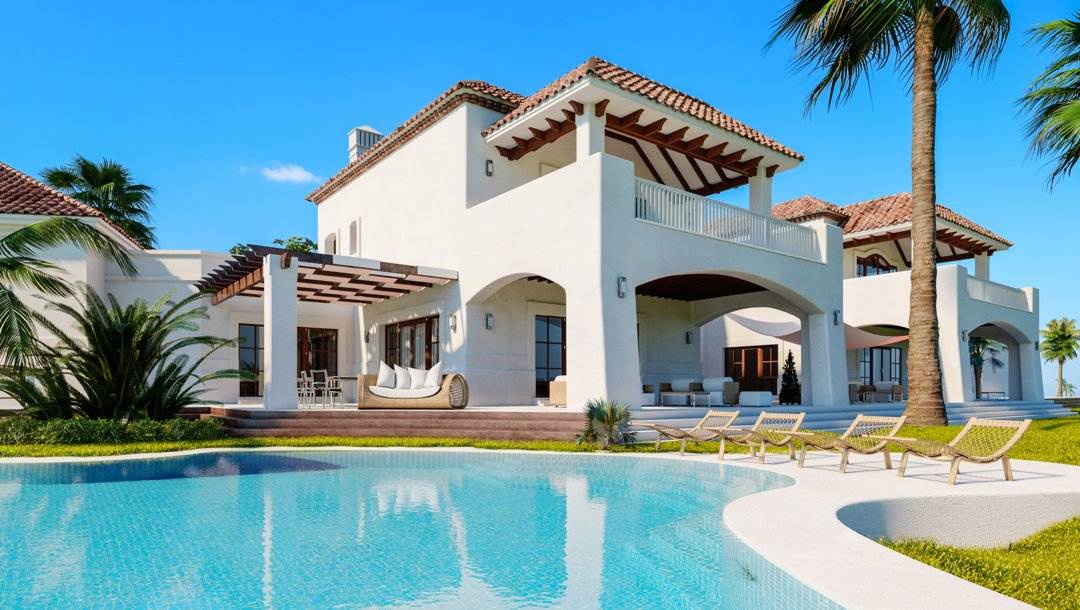 The exterior of a luxurious two-story private villa. Several loungers, couches and palm trees surround a large pool outside.