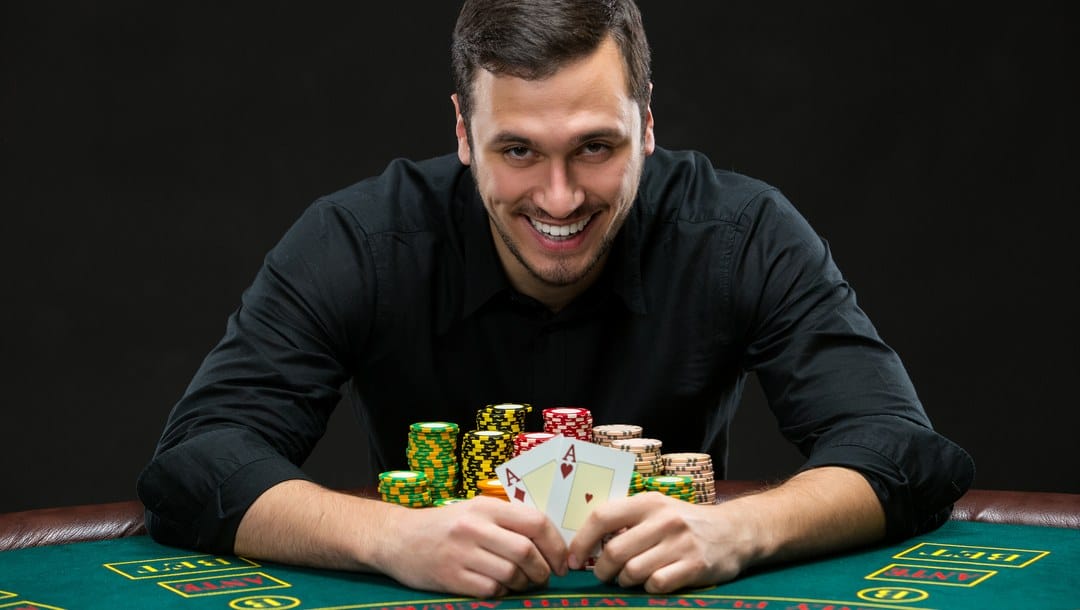 A poker player reveals his winning pair of aces.