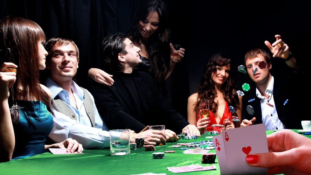 A group of players enjoy themselves at the poker table.