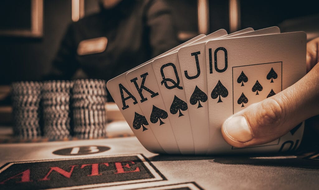 A poker player reveals a royal flush.