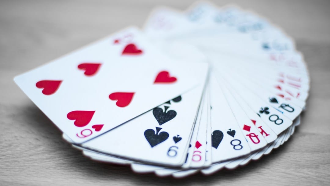 Playing cards deck isolated on a gray wooden background.