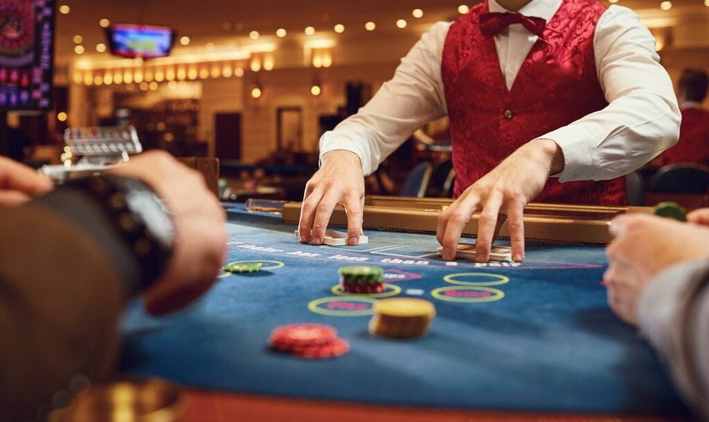 A poker dealer shuffles his cards between hands.