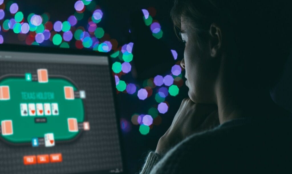 A woman playing Texas Hold’em on a PC.