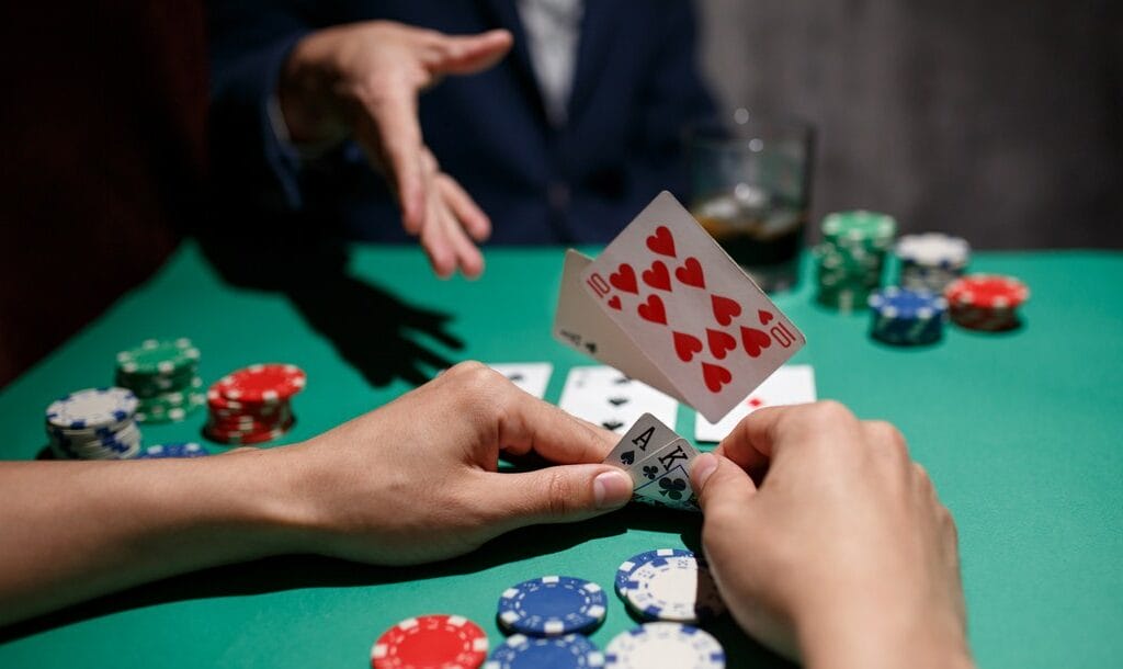 A poker player throws their cards onto the table.