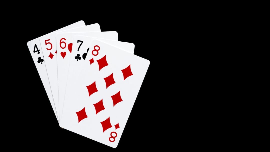 A low straight combination in poker on a black background.