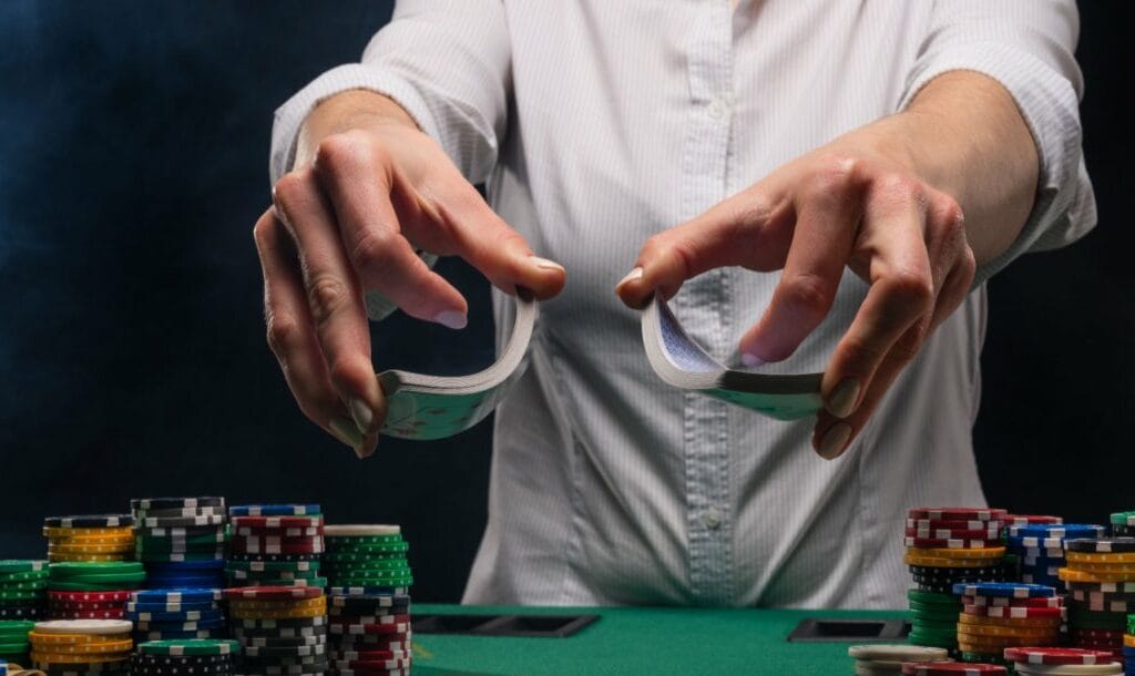 A poker dealer holding a deck of cards.