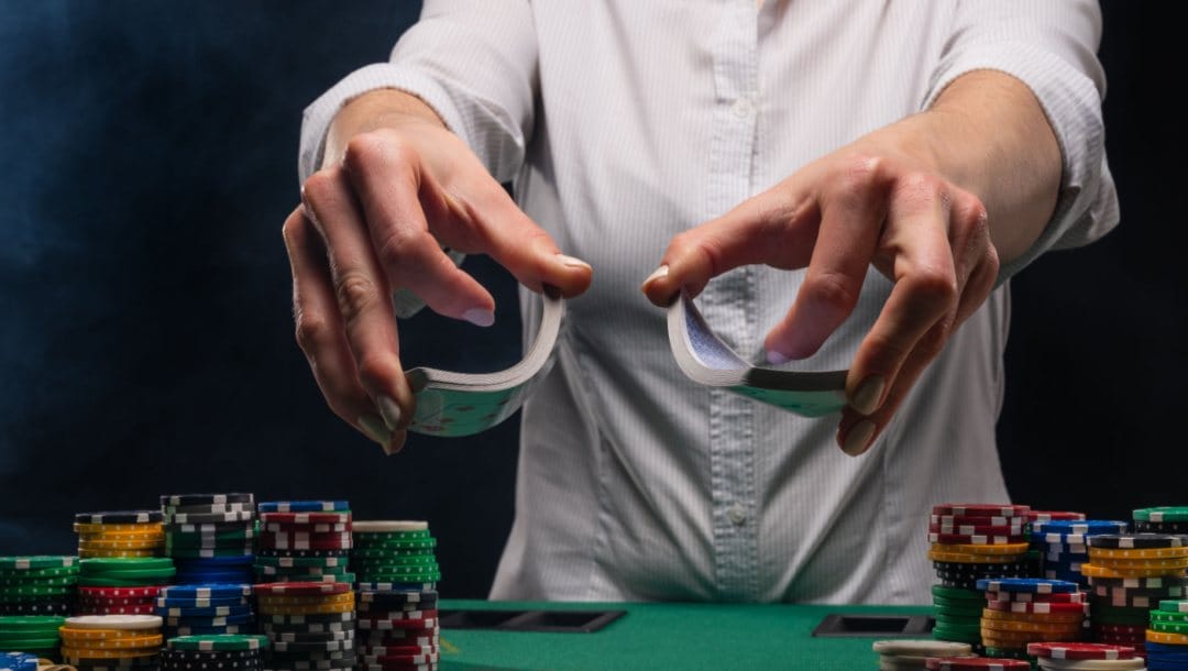 A poker dealer holding a deck of cards.