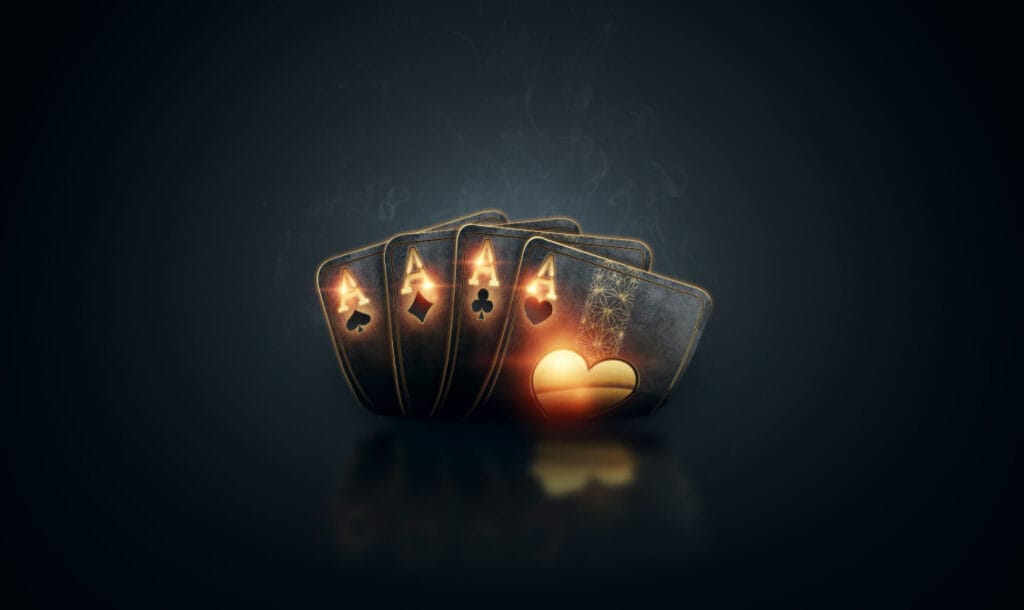 Black and gold playing cards against a black backdrop.