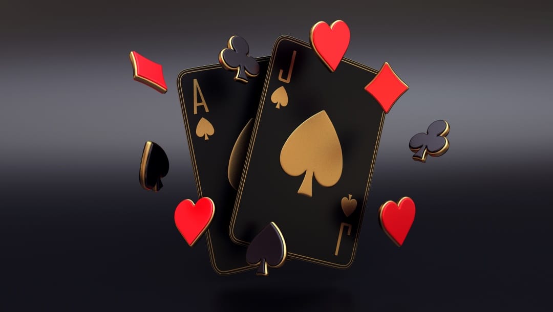 Black and gold casino cards and playing suites against a black background.
