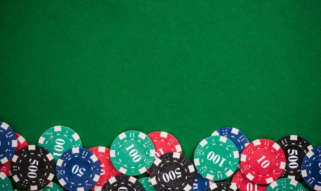 Casino chips on a green felt table.