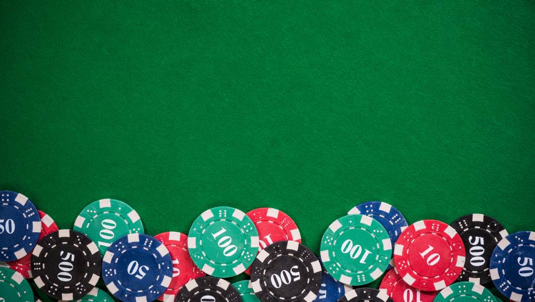 Casino chips on a green felt table.
