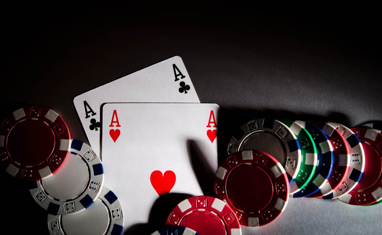 Two ace playing cards surrounded by poker chips.