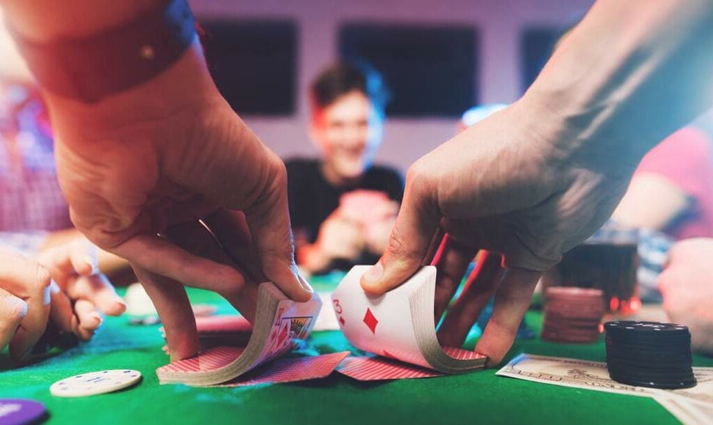 A person shuffles cards for a poker game.