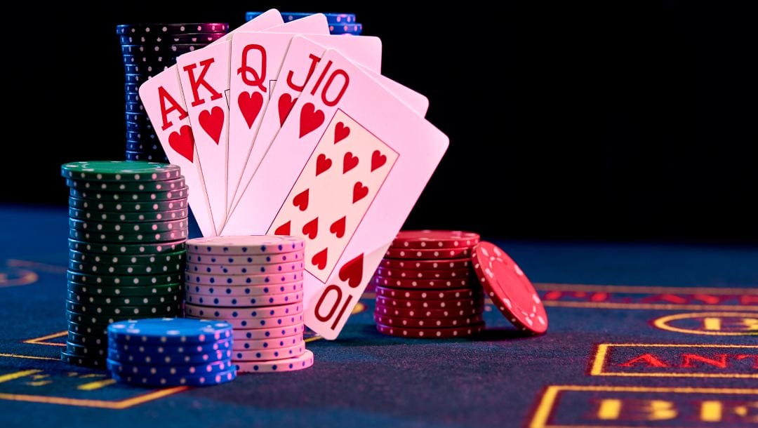 Playing cards and casino chips on a poker table.
