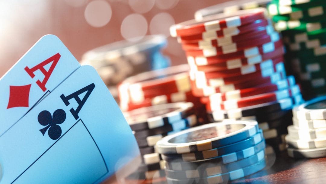 Playing cards and poker chips on a wooden table.
