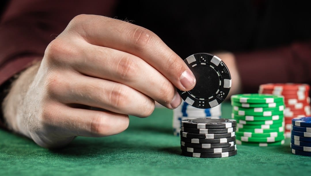 A poker player deciding how many chips to wager.