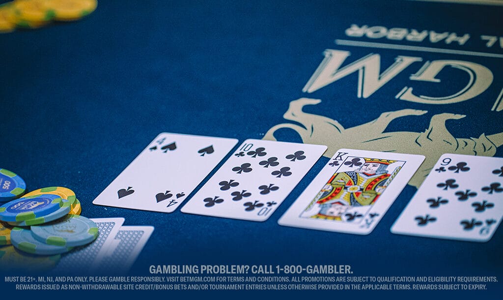 Poker game in progress on a blue felt table with four face-up cards: ace, ten, king of clubs, and a six. Nearby, poker chips are stacked neatly.