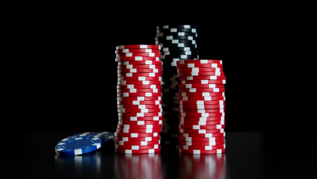 Stacks of casino chips against a black backdrop.