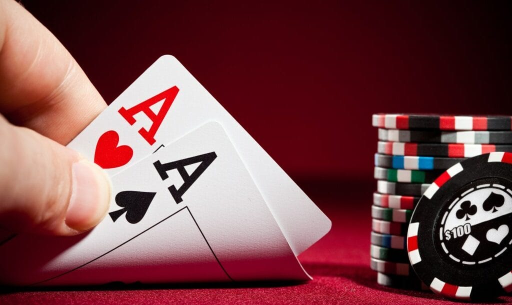 Poker cards and chips on a red felt table.