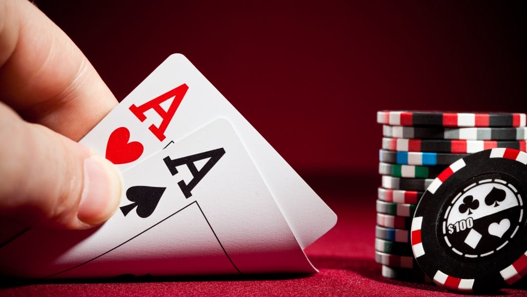 Poker cards and chips on a red felt table.