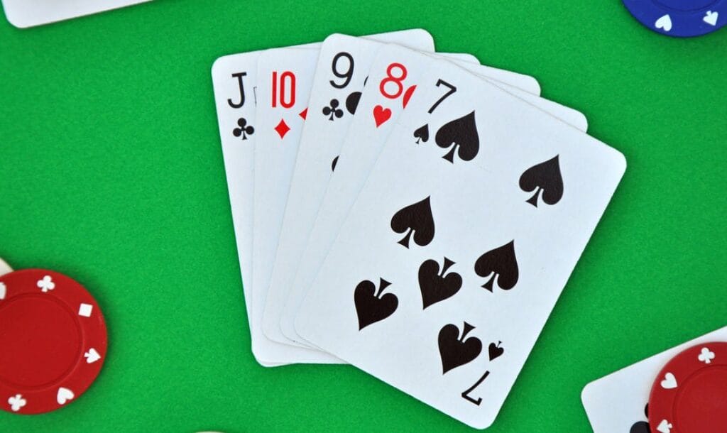 A straight from jack down to seven on a poker table with chips