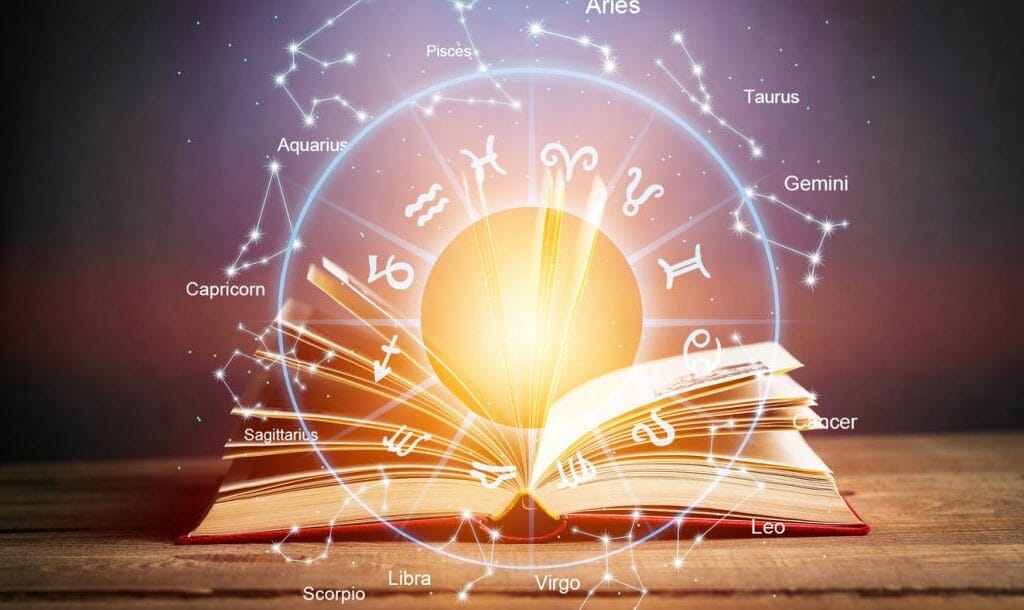 An astrology chart featured over an open book.