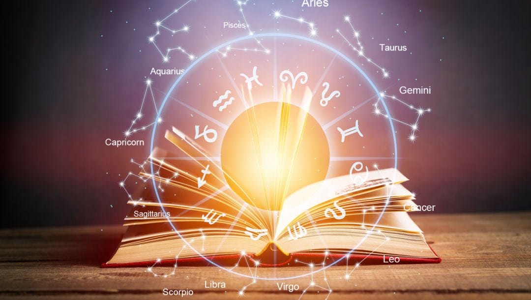 An astrology chart featured over an open book.