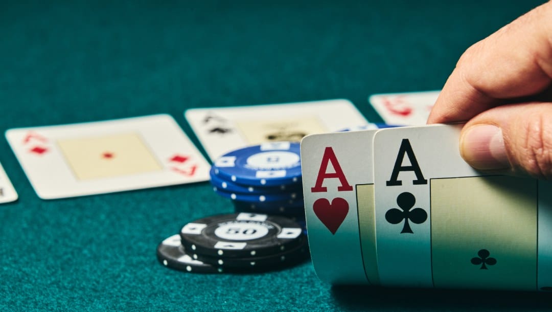 Playing cards and casino chips on a poker felt table.