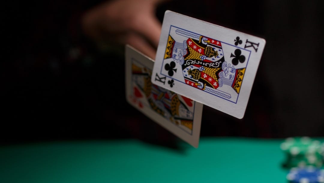 A poker player tosses his cards when folding. His hand was a king of clubs and a queen of hearts
