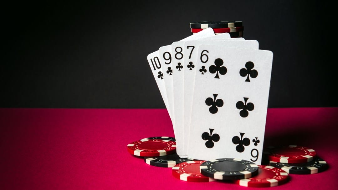 Poker cards and casino chips on a red felt table.