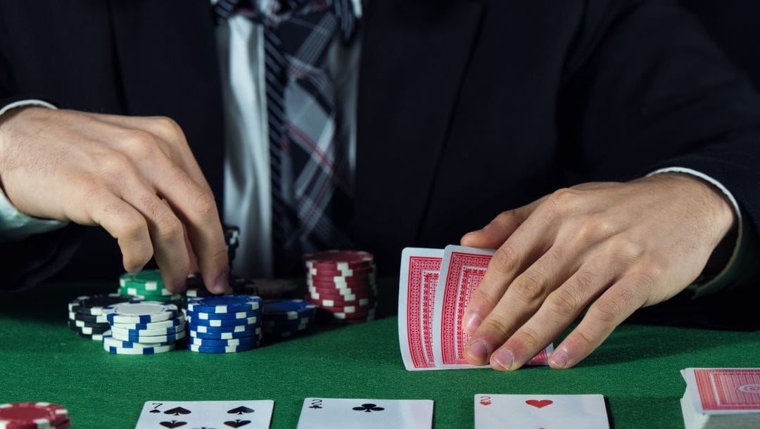 Man playing poker deciding whether to bet or fold