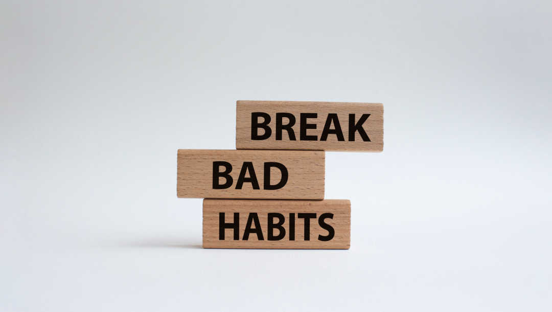 A picture of wood bricks with “break bad habits” written on them