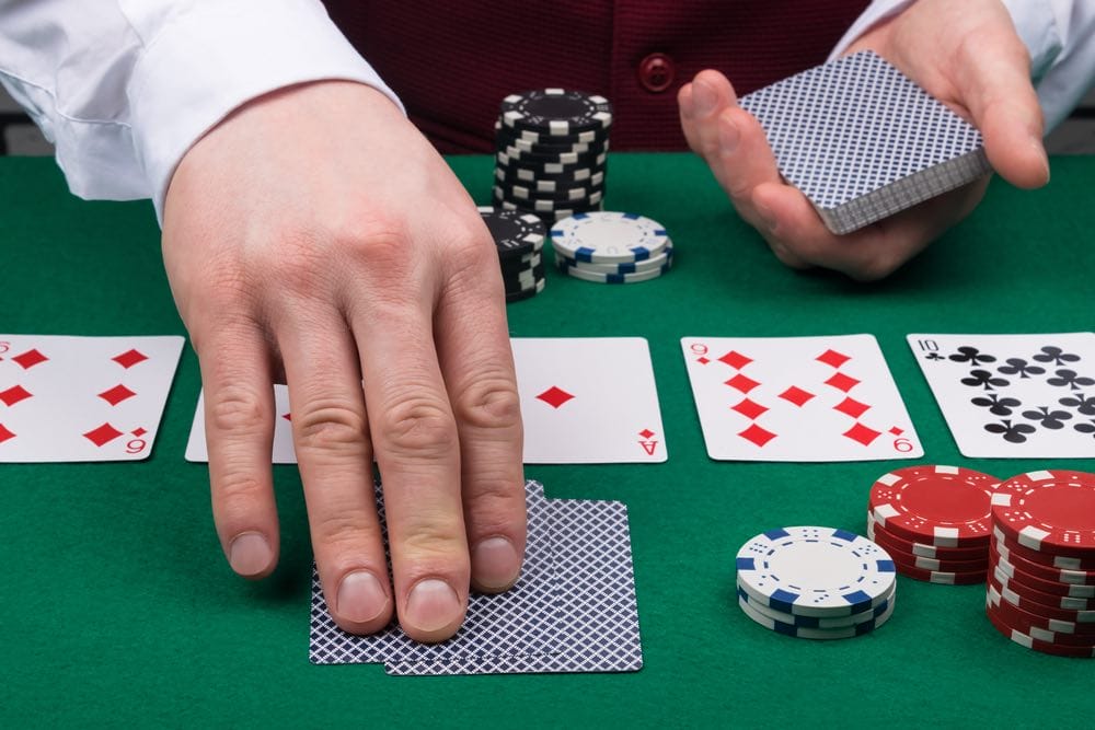 Dealer laying out poker cards.