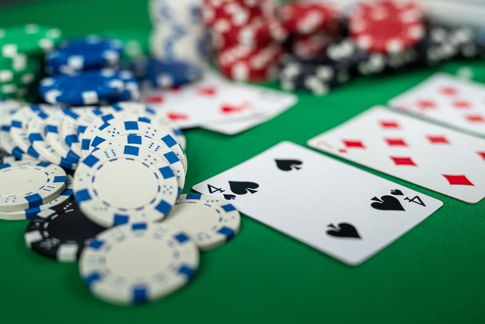 Poker cards and chips on a green felt table.