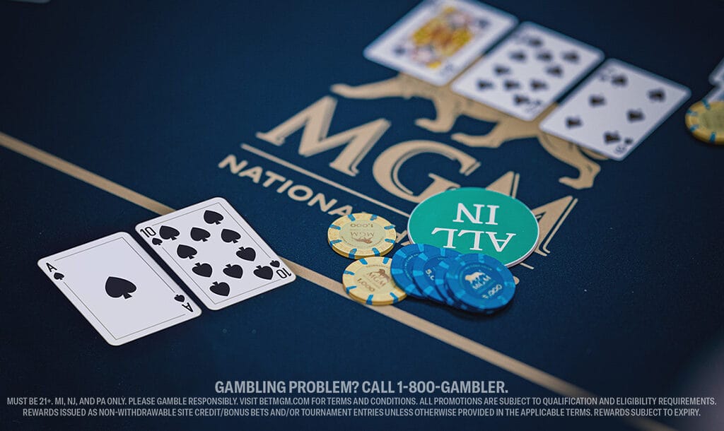 Close-up of a poker table at MGM National Harbor shows Ace and Ten of Spades, chips, an “ALL IN” token, and three community cards—King of Hearts, Nine of Spades, and Eight of Clubs.