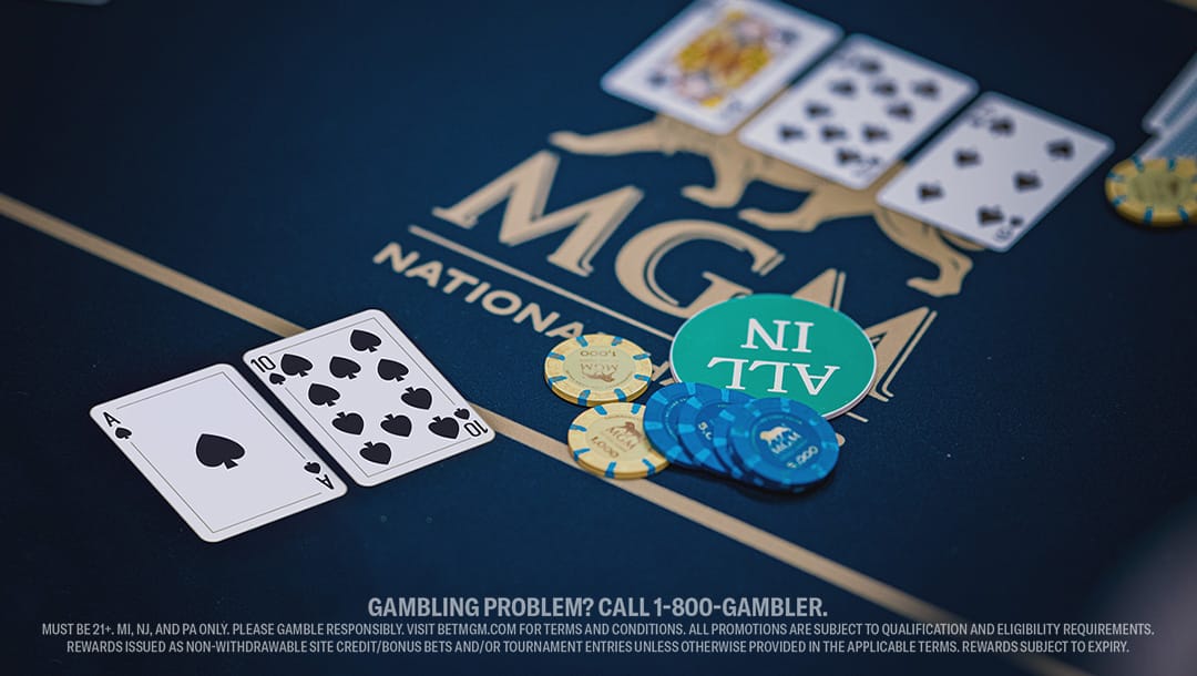 Close-up of a poker table at MGM National Harbor shows Ace and Ten of Spades, chips, an “ALL IN” token, and three community cards—King of Hearts, Nine of Spades, and Eight of Clubs.