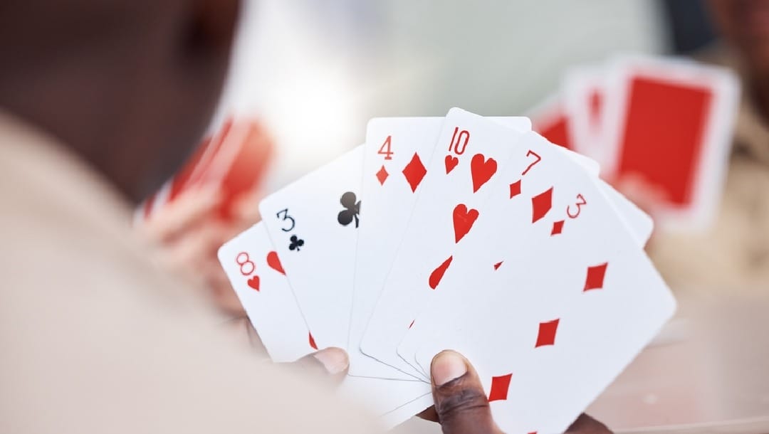 A beginner poker player looking at the cards in his hand
