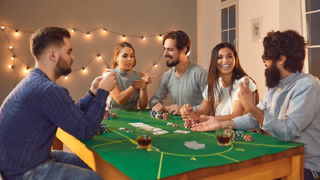 A group of friends playing poker at home around a poker table
