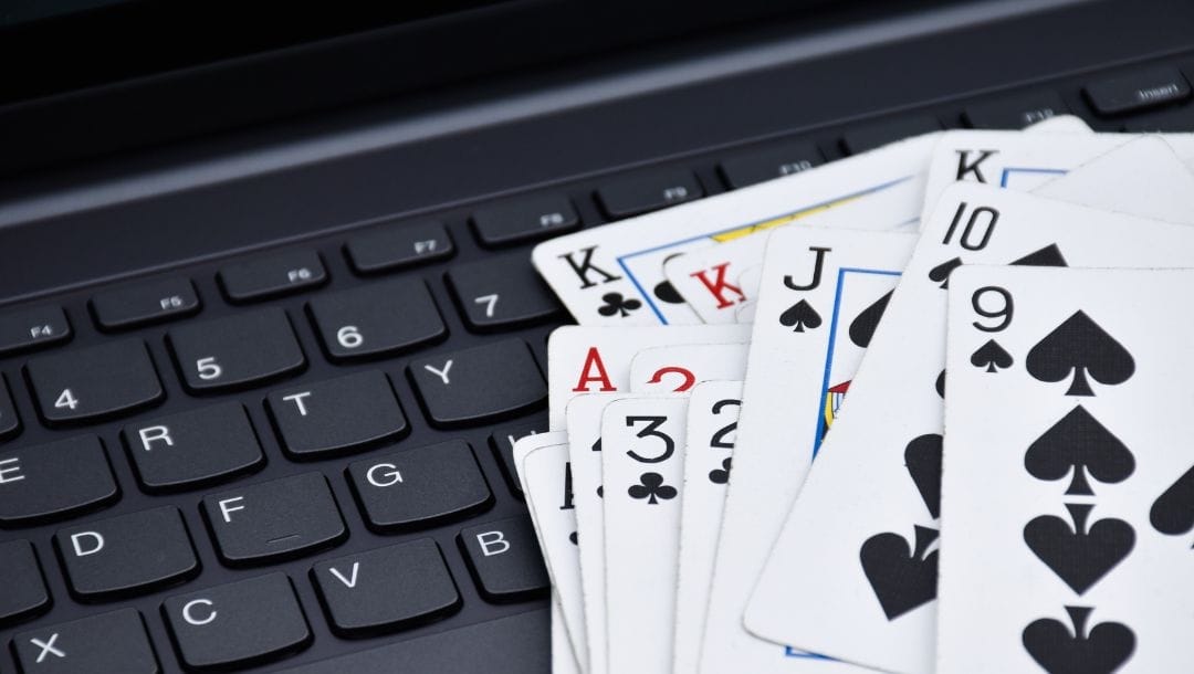 playing cards on a laptop keyboard