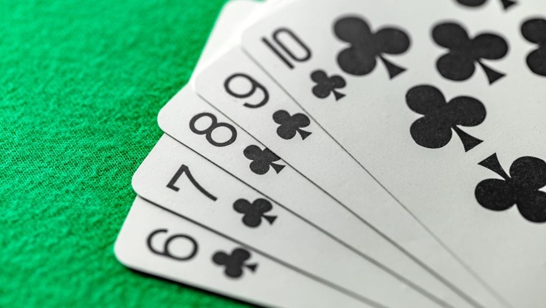 a straight of clubs from six to ten on a green felt poker surface