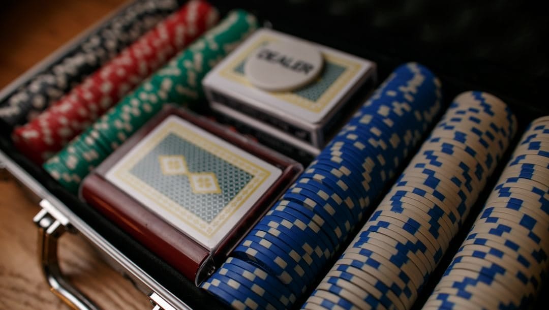 a complete poker chip set comprising of multicolored poker chips, playing cards and a dealer token in an aluminum case
