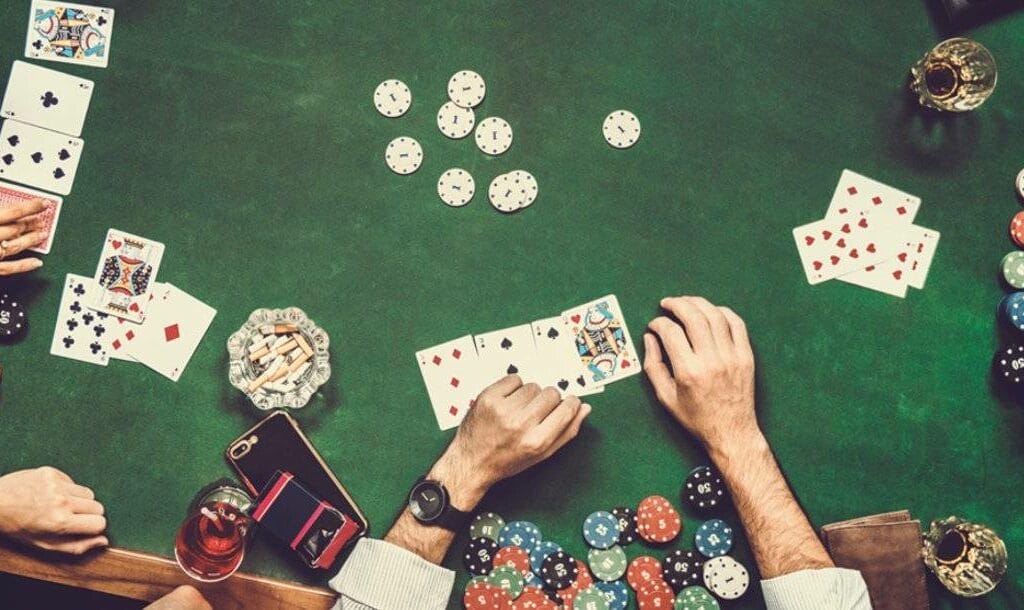 A view from above a poker table with friends playing a poker game together.