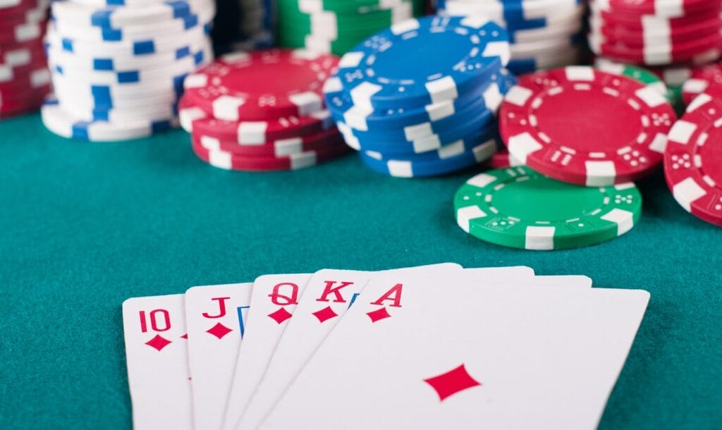 Playing cards and casino chips on a poker table.