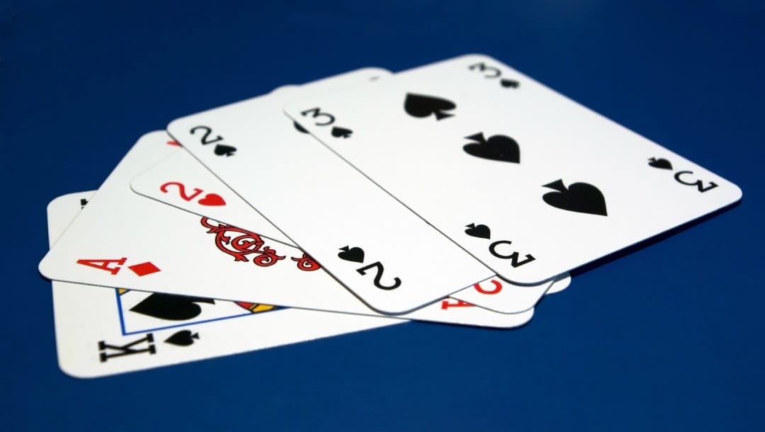 Playing cards on a blue surface.