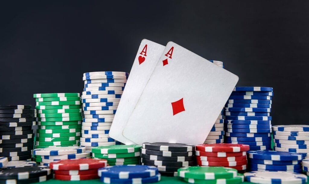 Poker cards and chips on a green felt table.