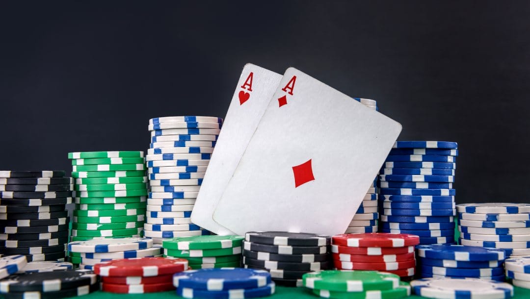 Poker cards and chips on a green felt table.