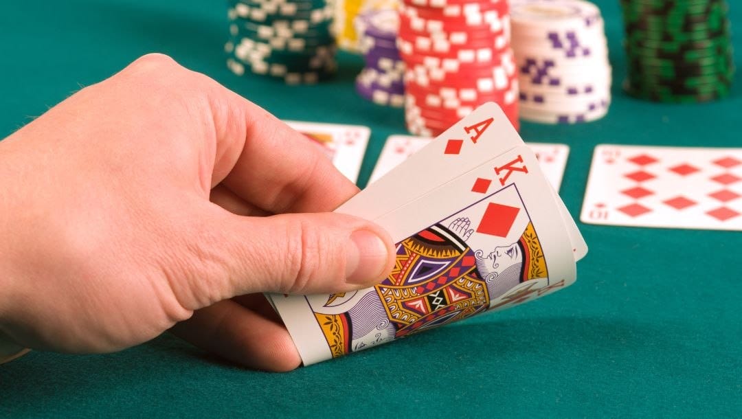 A hand revealing an Ace of Diamonds, and a Kind of Diamonds.