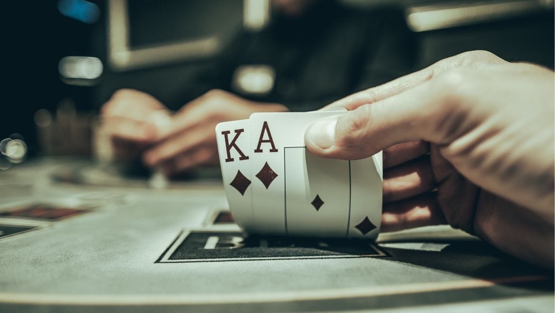 A hand revealing a King of Diamonds, and an Ace of Diamonds.